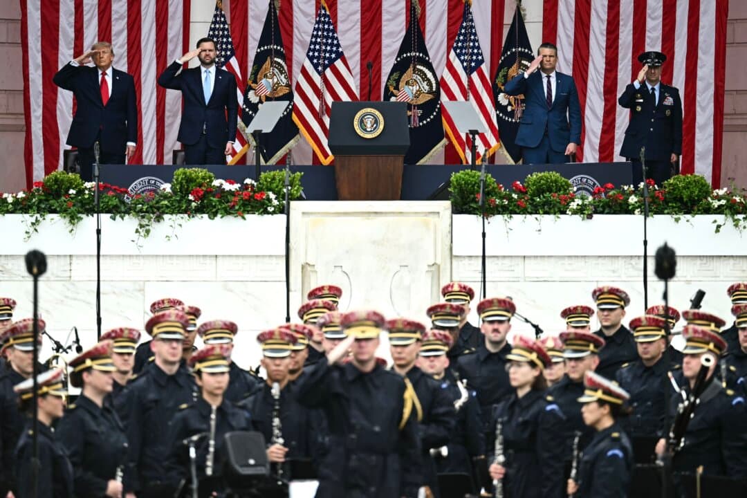 (L-R) President Donald Trump, Vice President JD Vance, War Secretary Pete Hegseth, and Chairman of the Joint Chiefs of Staff Gen. Dan Caine salute during the National Memorial Day Observance in Arlington, Va., on May 25, 2026. (Kent Nishimura/AFP via Getty Images)
