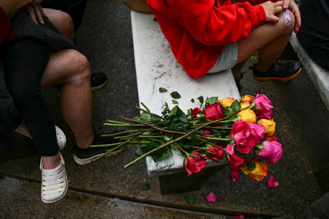 Flowers lay on a bench as audience members listen to President Donald Trump during the National Memorial Day Observance at the Memorial Amphitheater in Arlington National Cemetery in Arlington, Va., on May 25, 2026. (Kent Nishimura/AFP via Getty Images)