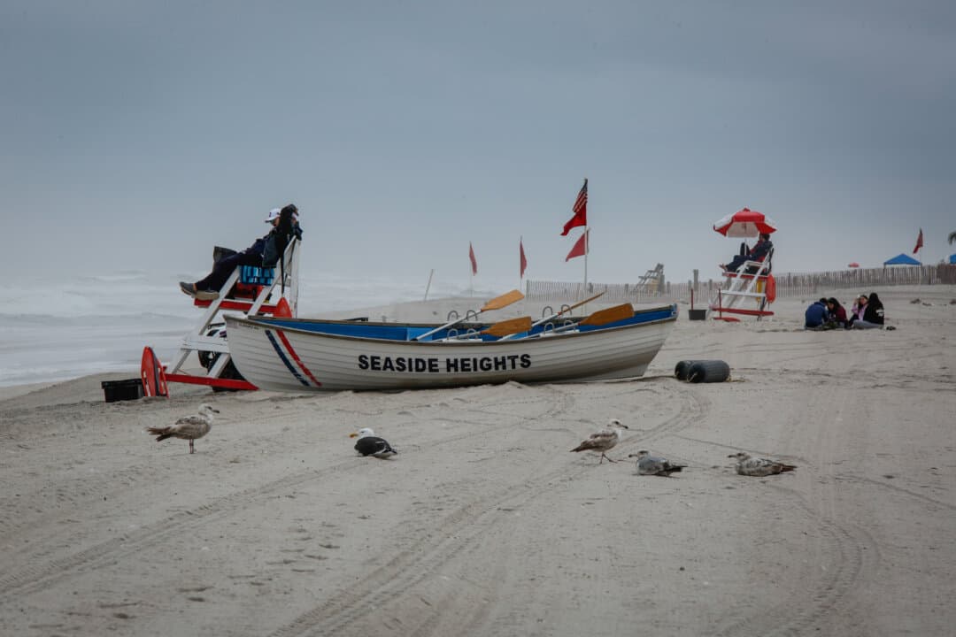 A beach lifeguard sits on a bench as low temperatures affect Seaside Heights, N.J., on May 25, 2026. The Memorial Day holiday weekend traditionally signifies the beginning of beach season in New Jersey. (Kena Betancur/Getty Images)
