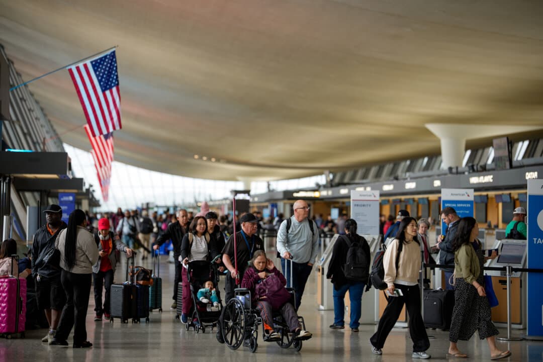 Travelers move through Washington Dulles International Airport in Dulles, Va., on May 22, 2026. The American Automobile Association expects a record 45 million Americans to travel over Memorial Day weekend, with highways and airports nationwide preparing for one of the busiest holiday travel periods on record despite rising fuel and airfare costs. (Andrew Harnik/Getty Images)