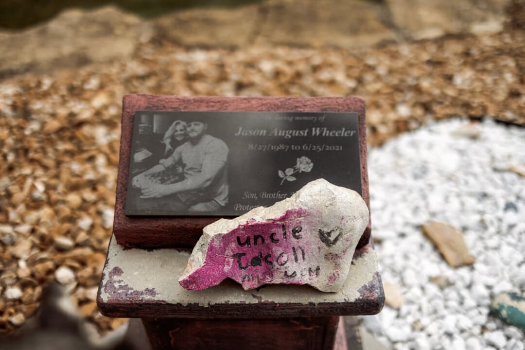 (Top) A baseball bat belonging to Jason Wheeler is displayed in Lee’s Summit, Mo., on May 23, 2026. Wheeler, who played baseball and football in college, died at age 33 from fentanyl. (Bottom) A memorial garden for Jason Wheeler at the home of Storm and Lance Dillenschneider in Lee’s Summit, Mo., on May 23, 2026. (Liz Davenport for The Epoch Times)