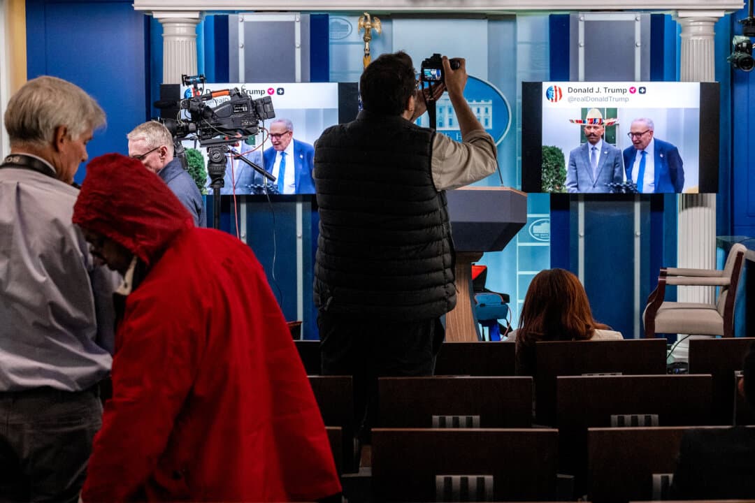 Journalists watch as an AI-generated fake video posted on President Donald Trump's Truth Social account plays in the Briefing Room at the White House on Oct. 1, 2025. Building on Trump's approach, other politicians have also adopted AI-generated content. (Jim Watson / AFP via Getty Images)