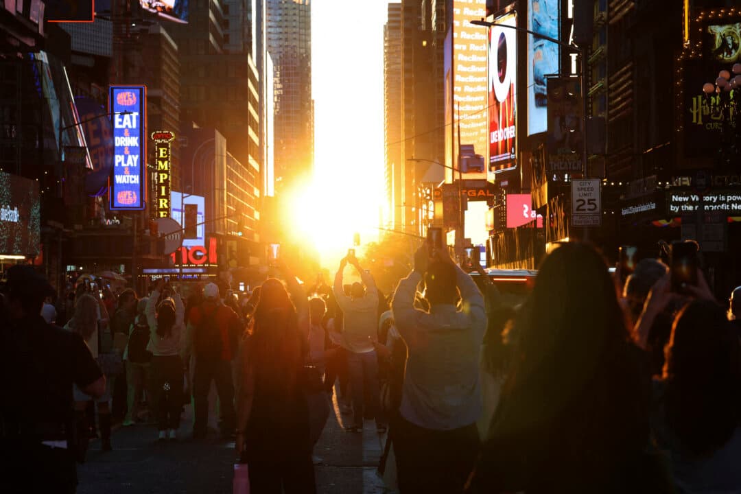 People stand in the middle of 42nd Street in Times Square for the first Manhattanhenge of 2026 in New York City on May 28, 2026. “Manhattanhenge,” coined by astrophysicist Neil deGrasse Tyson, is a phenomenon where the sun perfectly aligns with Manhattan’s street grid, allowing it to be seen directly between the city’s skyscrapers. (Timothy A. Clary/AFP via Getty Images)
