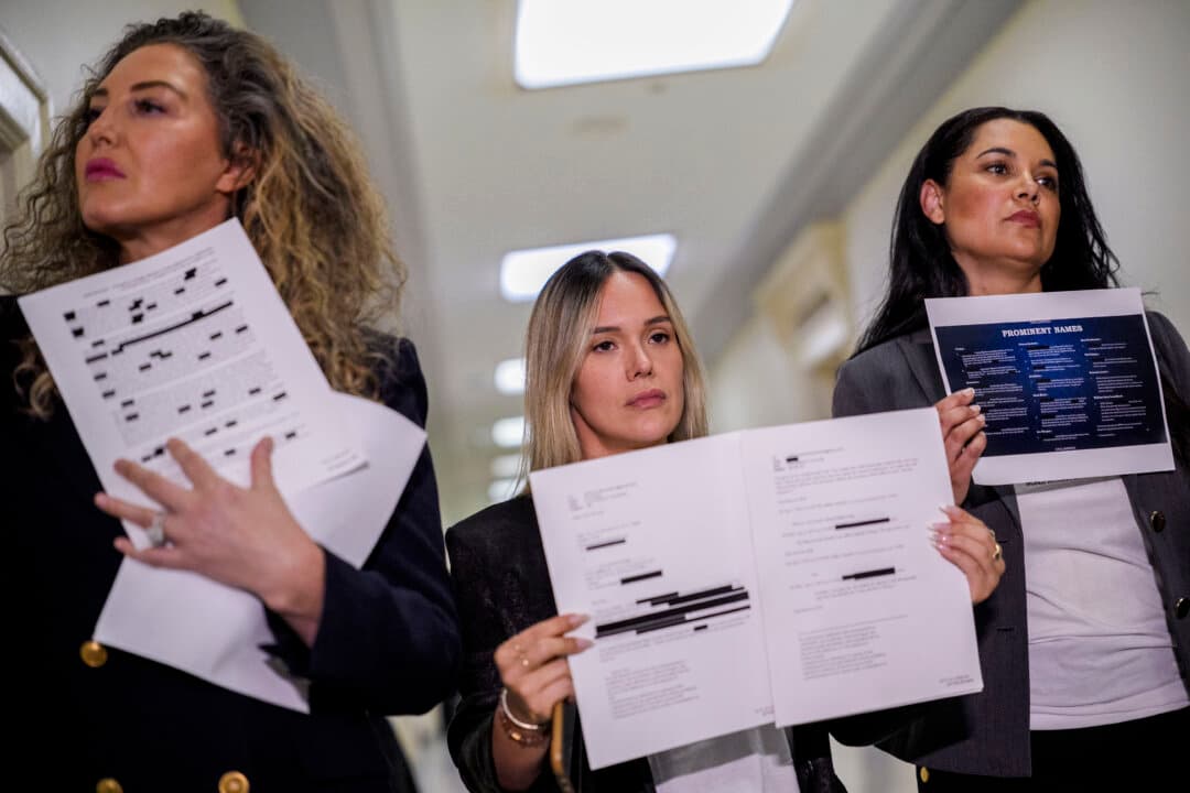Abuse survivors Lara Blume McGee, Andrea Sterling, and Sharlene Rochard hold up redacted documents related to the investigation of sex trafficker Jeffrey Epstein outside a House Oversight Committee closed-door interview with former U.S. Attorney General Pam Bondi on Capitol Hill in Washington on May 29, 2026. Bondi will be asked questions on the Department of Justice’s handling of the case and release of related files to the public. (Andrew Harnik/Getty Images)