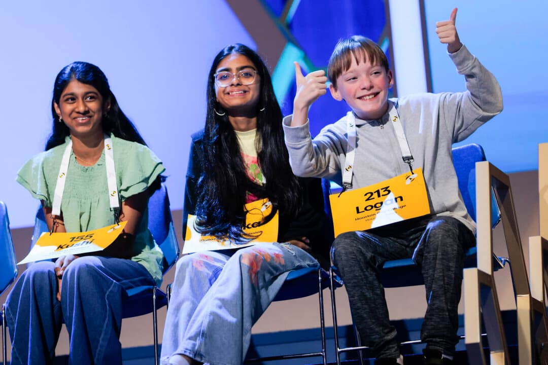 Speller Logan Bailey (R), 12, looks to the crowd during the final round of the Scripps National Spelling Bee at Constitution Hall in Washington on May 28, 2026. A total of 247 spellers, ranging in age from 9 to 15, are competing throughout the week in the 2026 Scripps National Spelling Bee. (Heather Diehl/Getty Images)