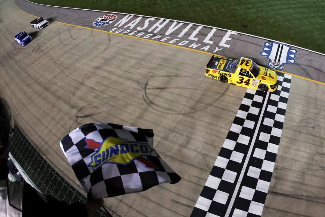 Layne Riggs, driver of the No. 34 Love’s Travel Stops–Fleetguard Ford, takes the checkered flag to win the NASCAR Craftsman Truck Series Allegiance 200 at the Nashville Superspeedway in Lebanon, Tenn., on May 29, 2026. (Jonathan Bachman/Getty Images)