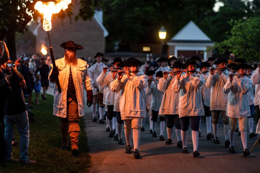 Fifers and drummers participate in the torch-lit Williamsburg Military Tattoo in Williamsburg, Va., on May 30, 2026. The Tattoo, originally an elaborate march used as a signal for soldiers to return to their barracks, was a highlight of the annual military music showcase called Drummer’s Call. (Mike Kropf/Getty Images)