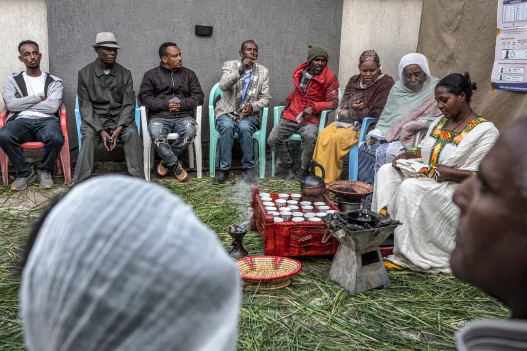 A woman prepares traditional coffee for voters waiting in line to vote at Shalla Park polling station in Addis Ababa, Ethiopia, on June 1, 2026, during the 2026 Ethiopian parliamentary elections. (Marco Simoncelli/AFP via Getty Images)