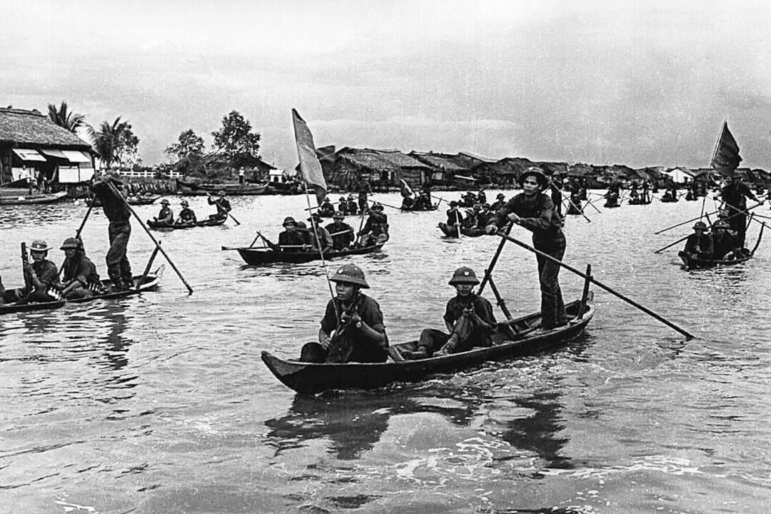 Viet Cong soldiers paddle small boats on their way to “liberate” the South Vietnamese town of Ca Mau, on May 1, 1975. After the fall of the South Vietnamese capital of Saigon on April 30, 1975, a wave of refugees settled in Orange County, California in what is now known as Little Saigon. The area is now home to the largest Vietnamese community outside Vietnam. (AFP via Getty Images)