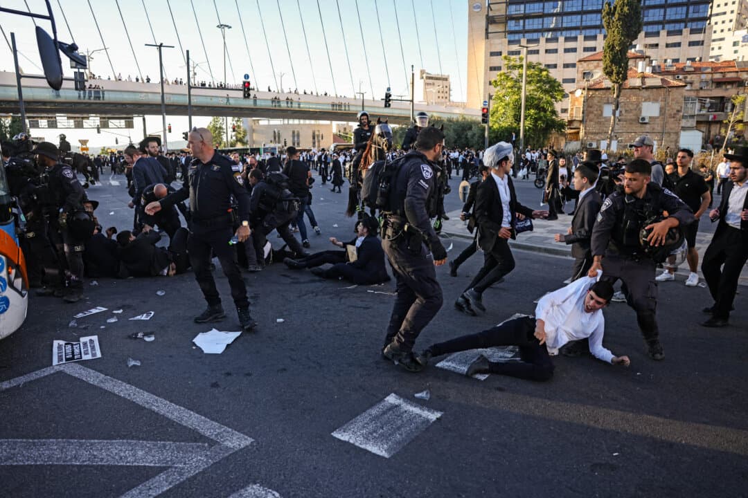 Israeli police disperse Orthodox Jews protesting against conscription by blocking the entrance to Jerusalem on June 1, 2026. They oppose a change to the law on compulsory military service, from which their community has traditionally been exempt. Under a provision established when the country was founded in 1948, men who dedicate themselves full-time to the study of Jewish sacred texts are effectively exempt. (Ahmad Gharabli/AFP via Getty Images)