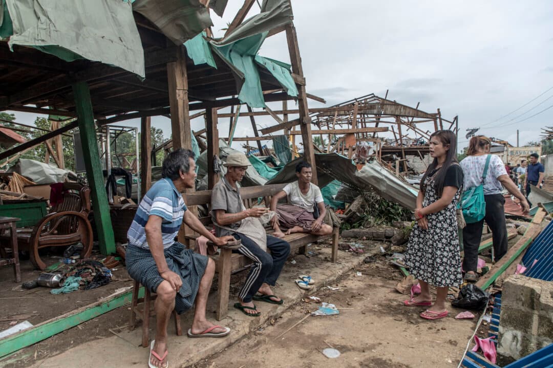 Local residents sit next to the debris of buildings destroyed in an explosion in Kaung Tat village, Burma, on June 2, 2026. (AFP via Getty Images)