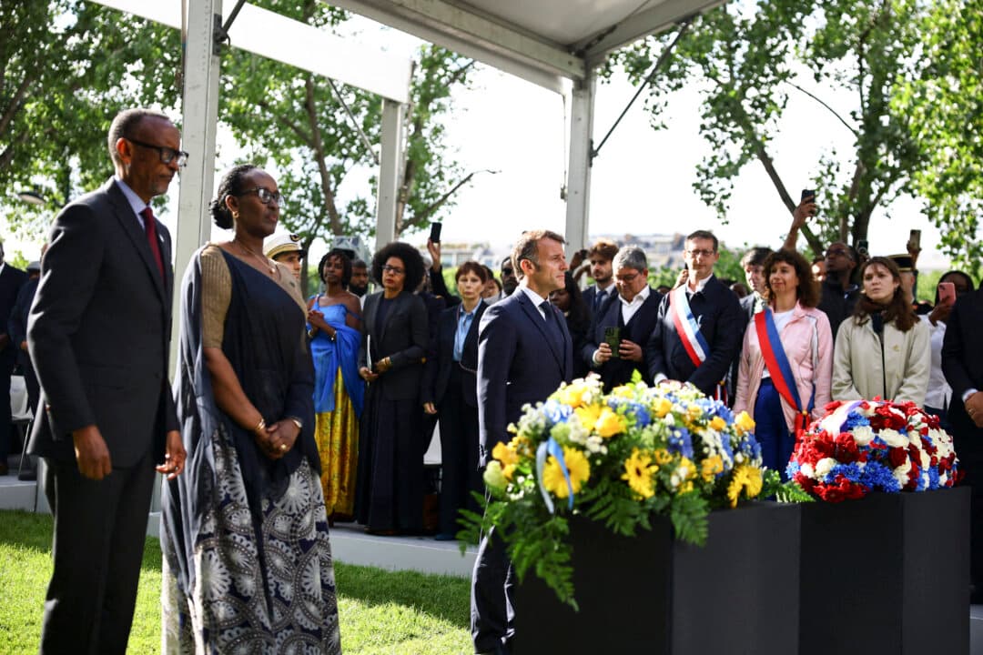 (From L) Rwanda’s President Paul Kagame, Rwanda’s First Lady Jeannette Kagame and France’s President Emmanuel Macron stand after laying wreaths of flowers on a monument, made by the Portuguese artist Grada Kilomba, for honoring the victims of the Rwanda’s genocide, during a ceremony on the Habib-Bourguiba Esplanade along the Seine River in Paris on June 2, 2026. (Sarah Meyssonnier/POOL/AFP via Getty Images)