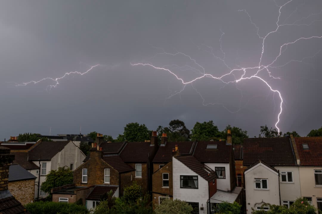 Lightning flashes are seen above homes in Bromley, England, on June 2, 2026. The Met Office issued a weather warning that heavy rain and thunderstorms were expected to cross the whole country on Monday. (Dan Kitwood/Getty Images)