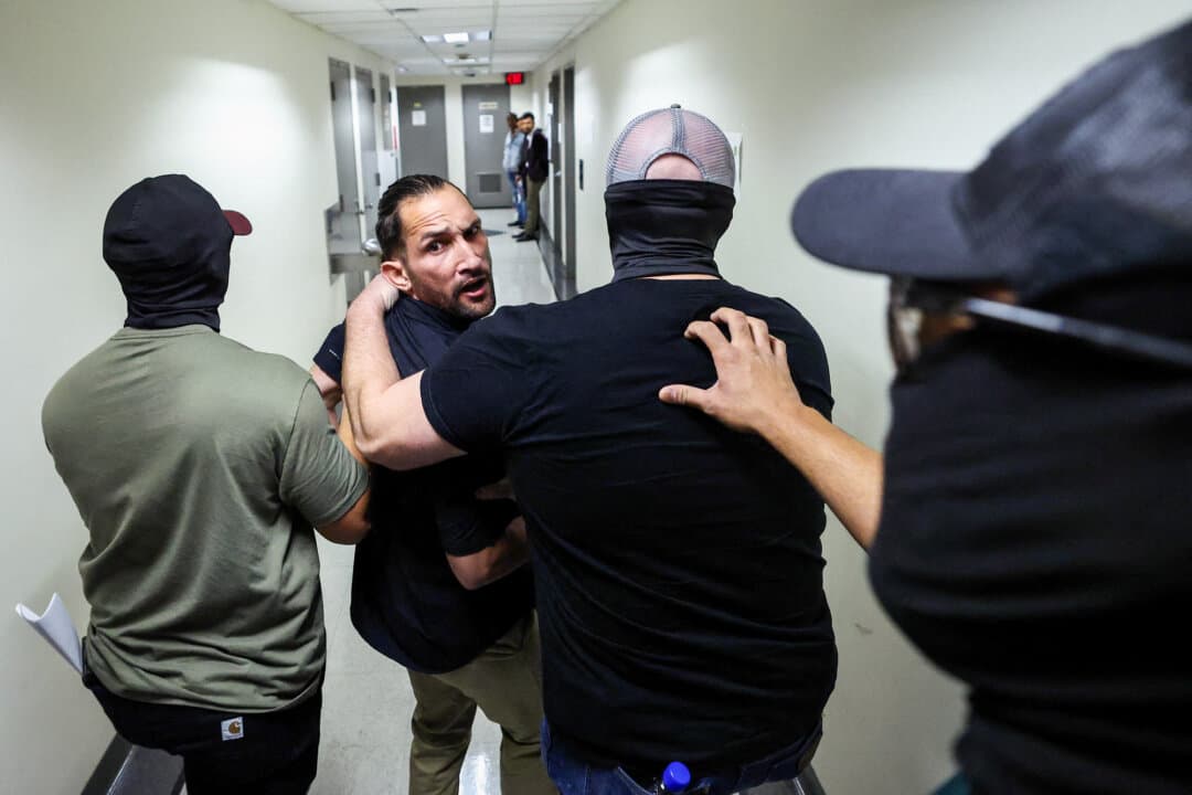 A man is detained by federal agents after his hearing at an immigration court inside the Jacob K. Javitz Federal Building in New York City on Oct. 1, 2025. A policy adopted by the Trump administration in 2025 represented a change from how previous administrations have interpreted the Immigration and Nationality Act. (Charly Triballeau / AFP/Getty)