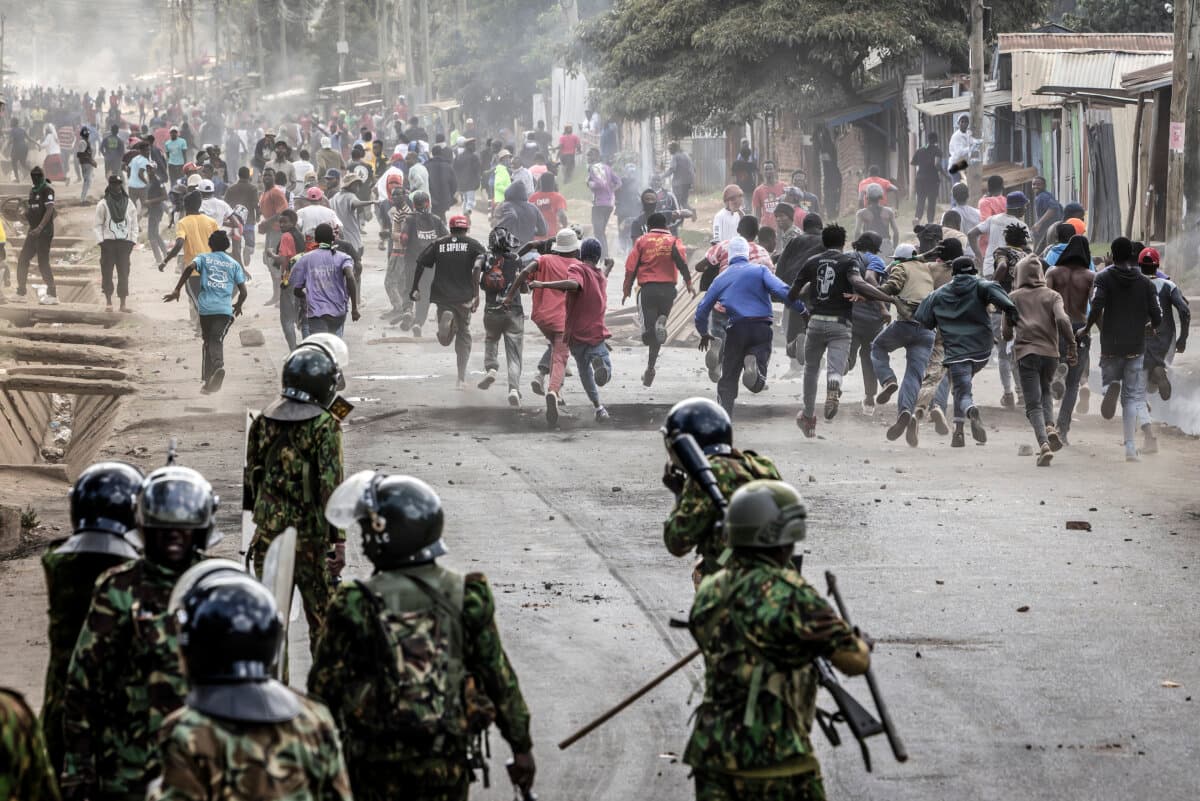 Demonstrators run for cover during clashes with Kenyan police officers at a demonstration against a controversial U.S.-built Ebola quarantine center slated to begin operations at Laikipia Air Base in Nairobi, Kenya, on June 9, 2026. (Luis Tato / AFP via Getty Images)