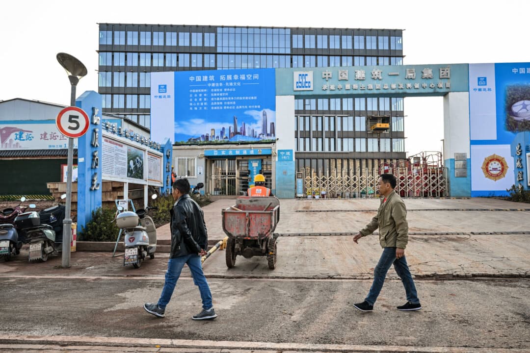 Construction workers at the site of the new headquarters of the China Rare Earth Group in Ganzhou, Jiangxi Province, China, on Nov. 21, 2025. The province is home to most of China's rare-earth mines, with the materials used in products from smartphones to missile guidance technology. (Hector Retamal / AFP via Getty Images)