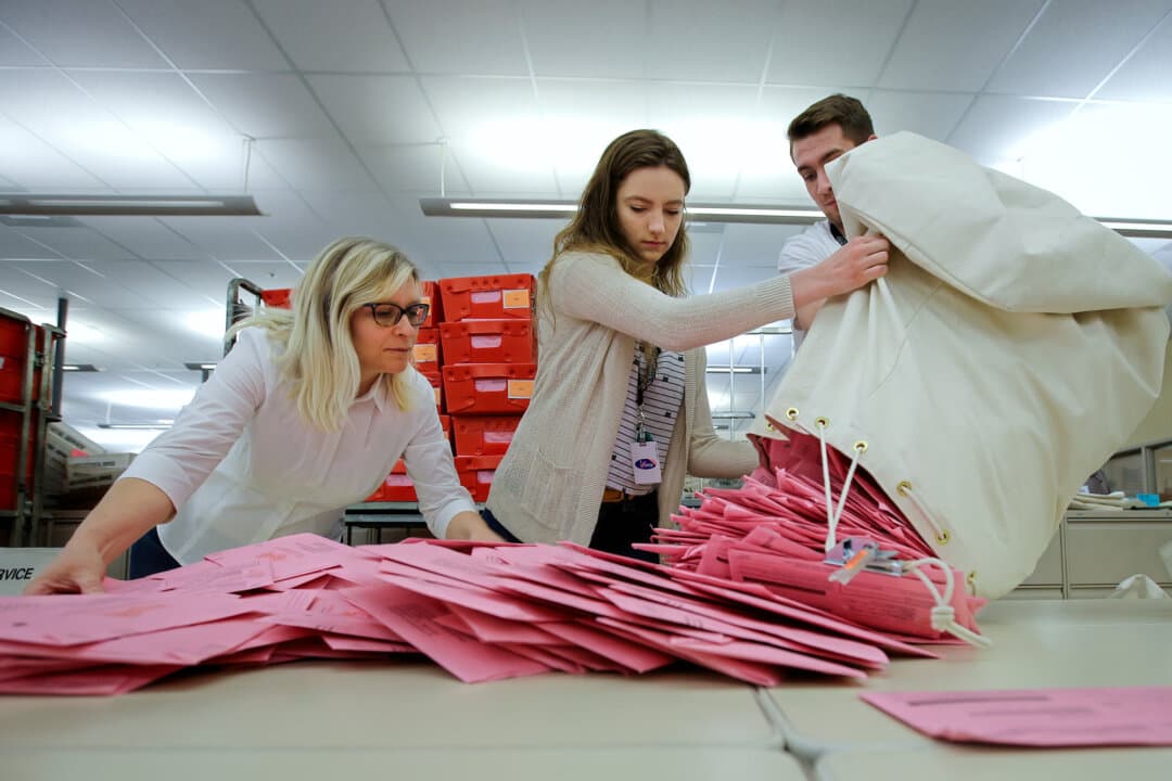 Election workers unload a bag of ballots brought in from a polling precinct to the Sacramento County Registrar of Voters office in Sacramento, Calif., on June 5, 2018. (Rich Pedroncelli/AP Photo, File)