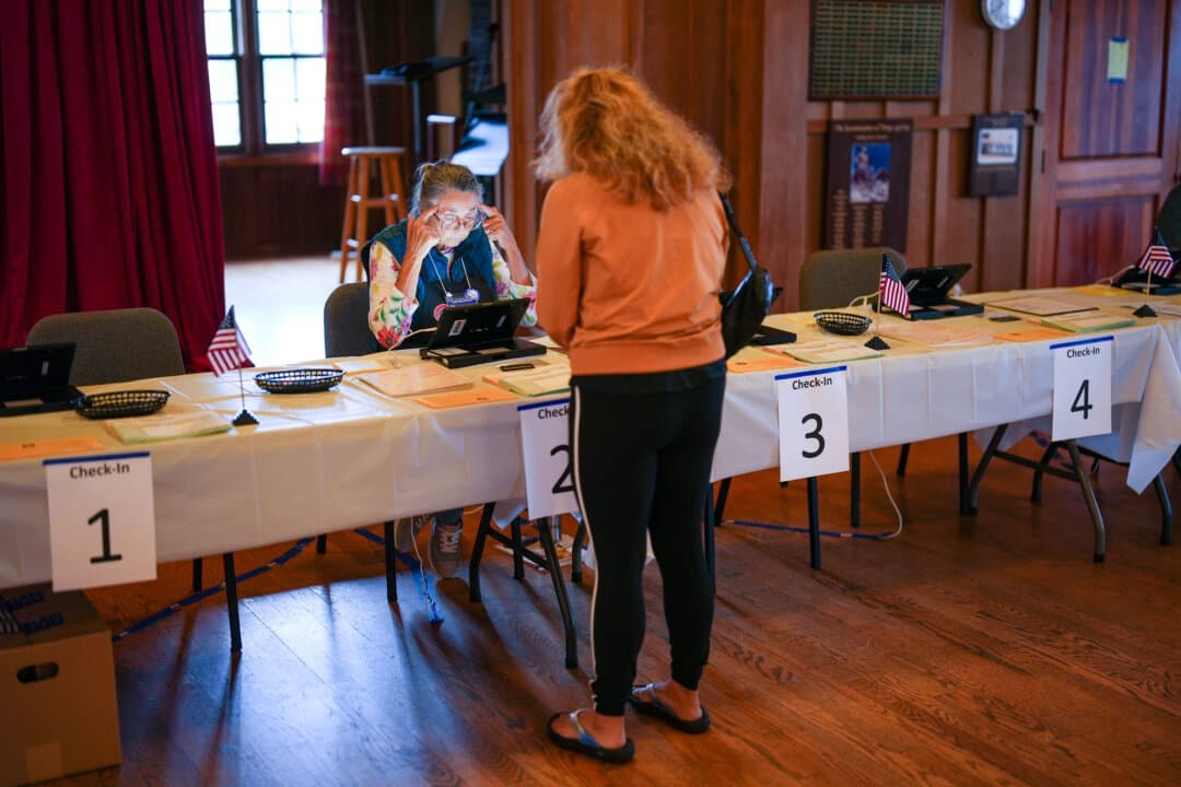 A voter checks in at a polling station in Del Mar, Calif., on, Nov. 4, 2025. (Gregory Bull/AP Photo)