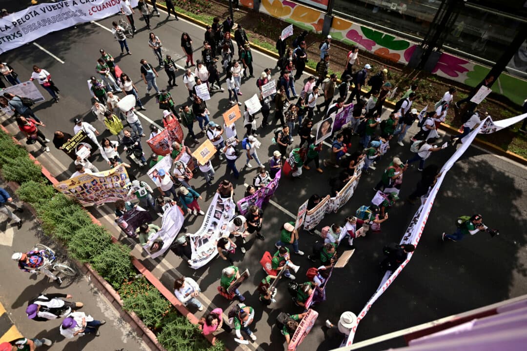Members of the “Madres Buscadoras” (Searching Mothers) collective march toward the Mexico City Stadium ahead of the opening ceremony for the FIFA 2026 World Cup in Mexico City, on June 11, 2026. The Mexican organization consists of women searching for their missing loved ones. (Marco Antonio Martinez/AFP via Getty Images)