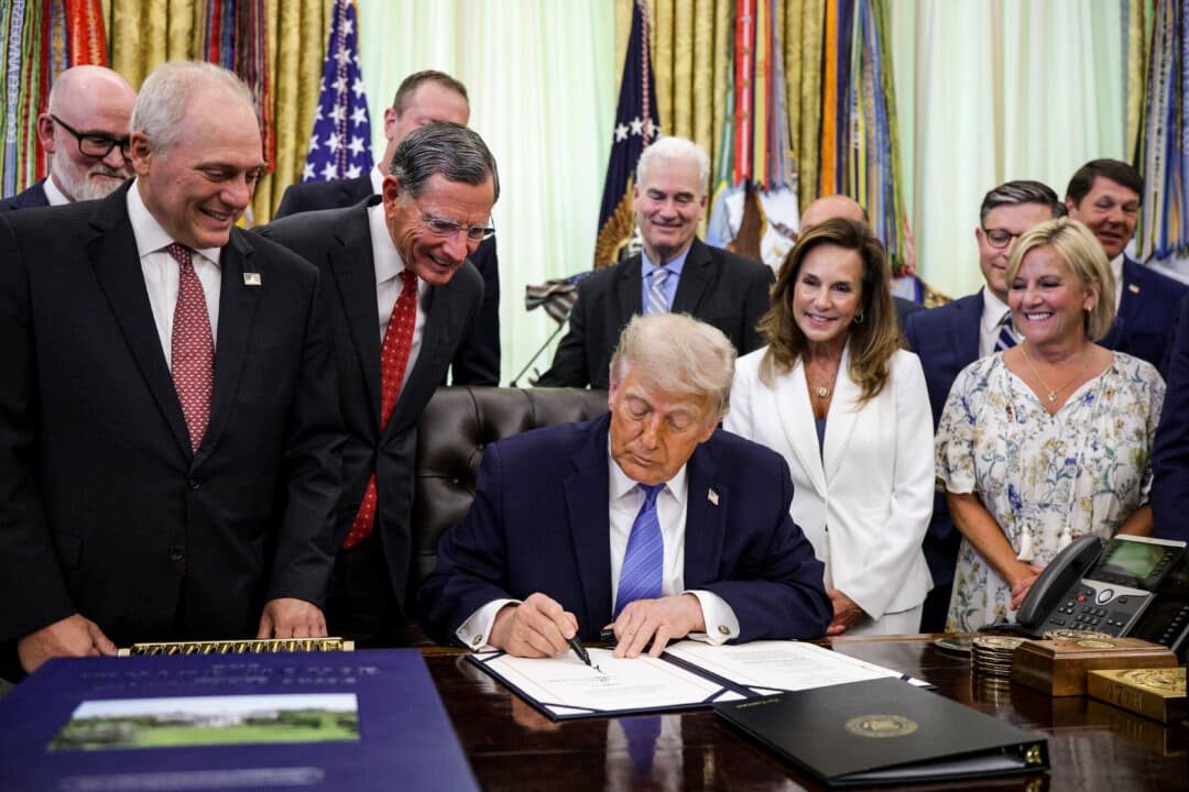 Members of Congress look on as President Donald Trump signs the Secure America Act in the Oval Office on June 10, 2026. The $70 billion package funds Border Patrol and Immigration and Customs Enforcement (ICE) operations through the end of Trump's term in office in fiscal year 2029. (Alex Wong/Getty Images)