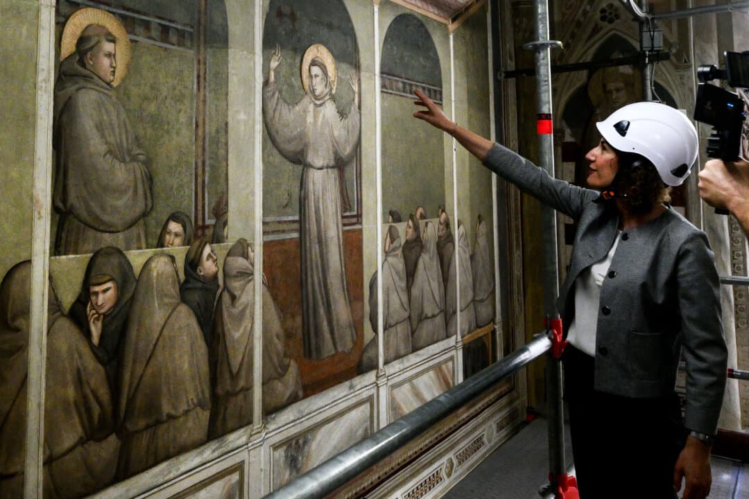 Head of the masonry department at the Opificio delle Pietre Dure, Renata Pintus, gestures during a press visit marking the completion of restoration work on Giotto’s 14th-century frescoes in the Basilica of Santa Croce in Florence, Italy, on June 12, 2026. The frescoes in the Bardi Chapel, depicting the life of St. Francis of Assisi, are undergoing final touches after a four-year restoration project ahead of their official unveiling. (Tiziana Fabi/AFP via Getty Images)