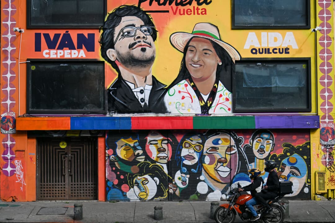 A motorcycle passes in front of a mural depicting Colombia’s presidential candidate for the Pacto Histórico party Iván Cepeda and vice-presidential candidate Aida Quilcué in Bogotá, Colombia, on June 12, 2026. The country is preparing for a presidential runoff election scheduled for June 21. (Juan Barreto/AFP via Getty Images)