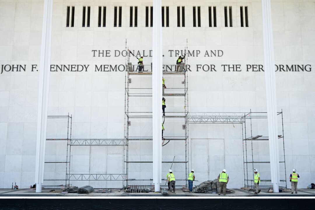 Workers stand on scaffolding near signage for the Donald J. Trump and John F. Kennedy Memorial Center for the Performing Arts as efforts continue to remove President Donald Trump’s name from the venue in Washington on June 12, 2026. A federal court ruling ordered the change following a legal dispute over the building’s naming. (Alex Wroblewski/AFP via Getty Images)