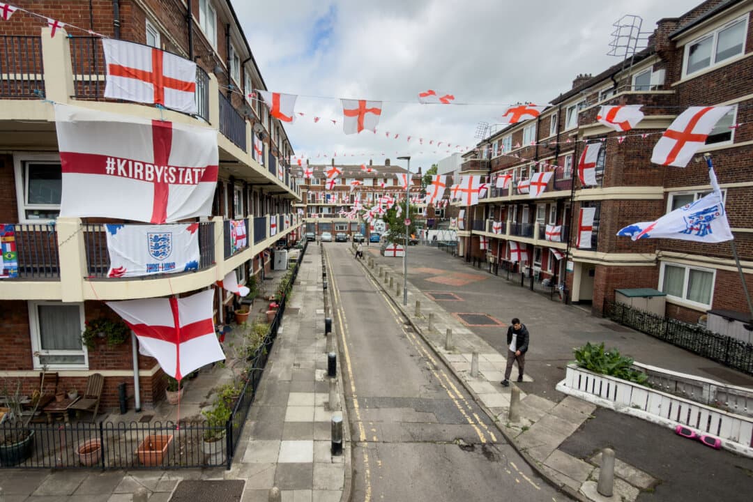 Hundreds of George Cross flags are displayed on balconies and lampposts as residents of the Kirby Estate decorate their homes in support of England’s bid to win the 2026 FIFA World Cup in London on June 12, 2026. England will play their opening match against Croatia in the tournament. (Leon Neal/Getty Images)