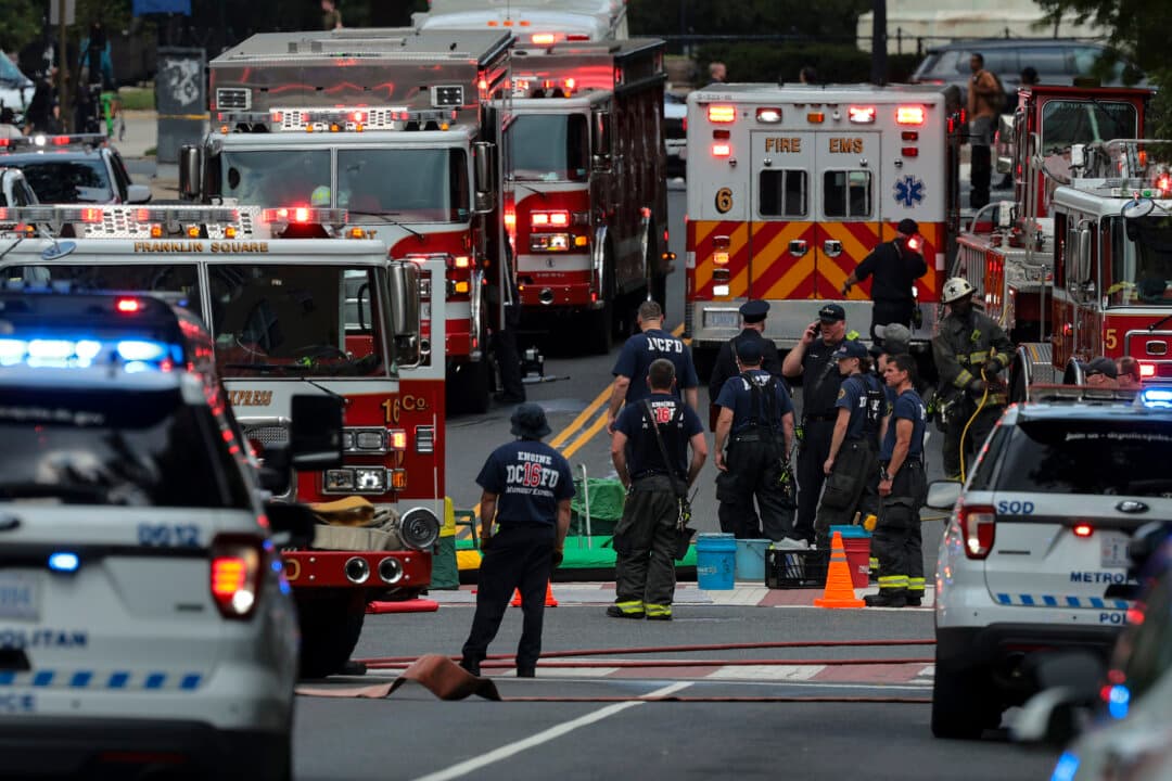 Emergency responders set up a decontamination unit in the middle of 23rd Street Northwest outside the Foggy Bottom Metro station in Washington on June 11, 2026. First responders were addressing the report of a suspicious package. (Chip Somodevilla/Getty Images)