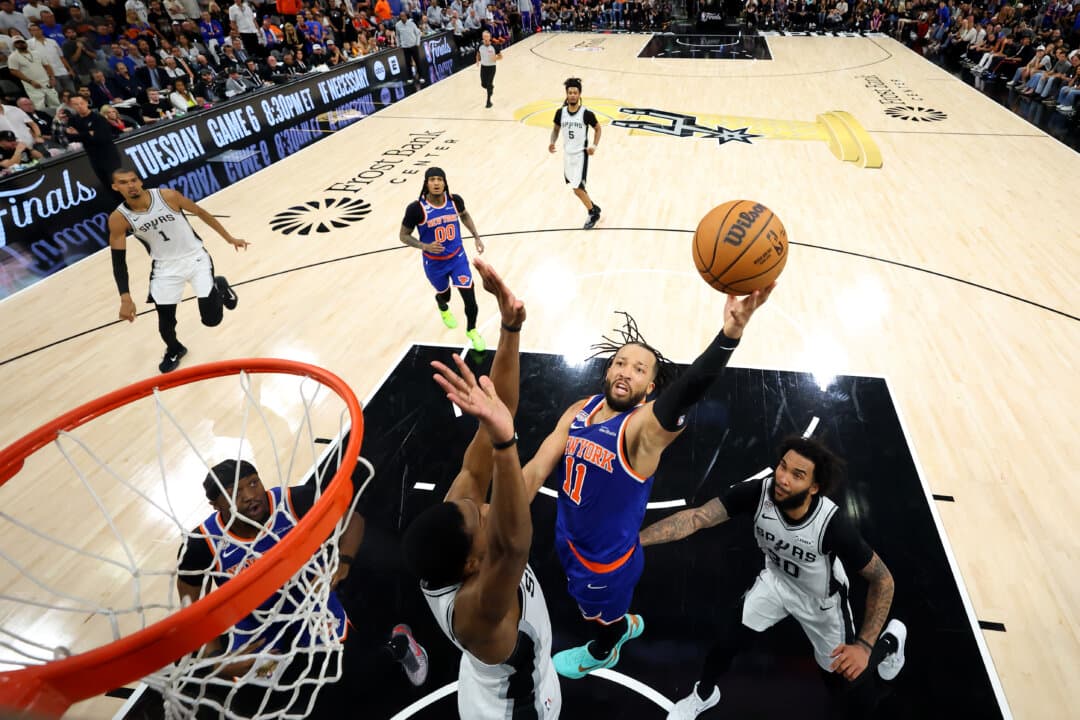 Jalen Brunson #11 of the New York Knicks shoots the ball against De'aaron Fox #4 of the San Antonio Spurs during the second half in Game Five of the 2026 NBA Finals at Frost Bank Center in San Antonio, Texas, on June 13, 2026. The Knicks defeated the Spurs by a score of 94–90, capturing their first NBA title in 53 years. (Eric Gay - Pool/Getty Images)