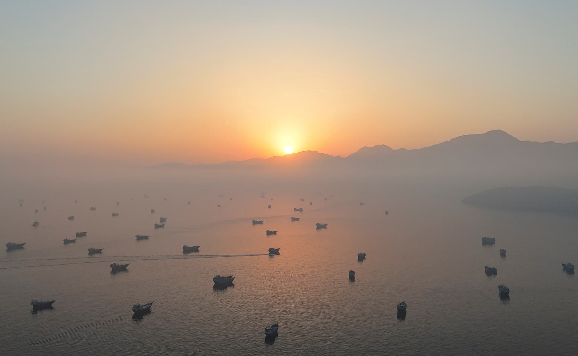 A drone view shows vessels in the Strait of Hormuz, as seen from Musandam, Oman, on June 15, 2026. (STR/Reuters)