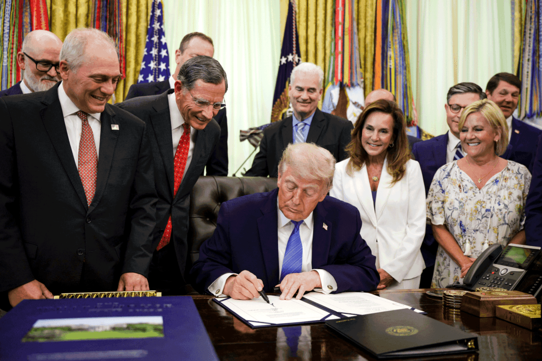 Members of Congress look on as President Donald Trump signs the Secure America Act in the Oval Office in Washington on June 10, 2026. The $70 billion package funds Border Patrol and Immigration and Customs Enforcement (ICE) operations through the end of Trump’s term in office in fiscal year 2029. (Alex Wong/Getty Images)