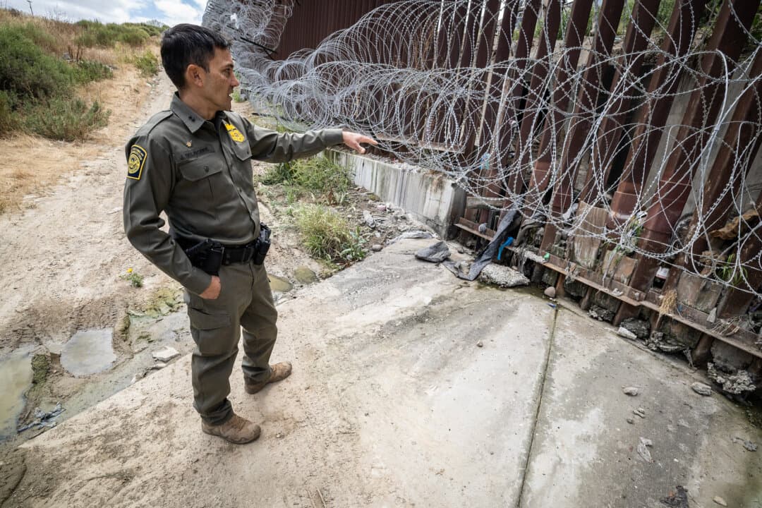 Chief Patrol Agent Justin M. De La Torre of the U.S. Border Patrol’s San Diego Sector checks the southern border wall outside San Diego on May 27, 2026. De La Torre highlighted increased coordination with Mexican law enforcement to intercept bad actors before they reach the U.S. border. (John Fredricks/The Epoch Times)
