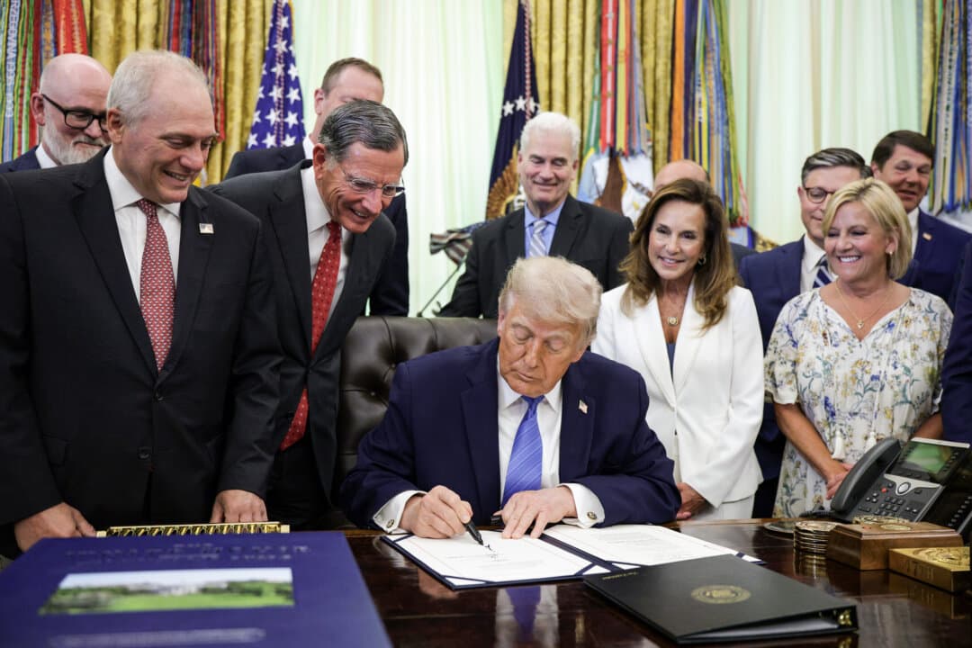 Members of Congress look on as President Donald Trump signs the Secure America Act in the Oval Office on June 10, 2026. The $72 billion package funds Border Patrol and Immigration and Customs Enforcement (ICE) operations through the end of Trump’s term in office in fiscal year 2029. (Alex Wong/Getty Images)