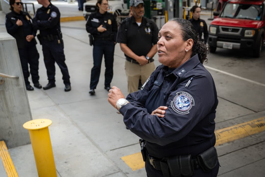 San Ysidro Port Director Mariza Marin works with colleagues at the San Ysidro Port of Entry near San Diego on May 26, 2026. Marin said the agency uses technology to compile traveler profiles, including travel history, travel methods, and other information, before a traveler reaches a primary officer. (John Fredricks/The Epoch Times)