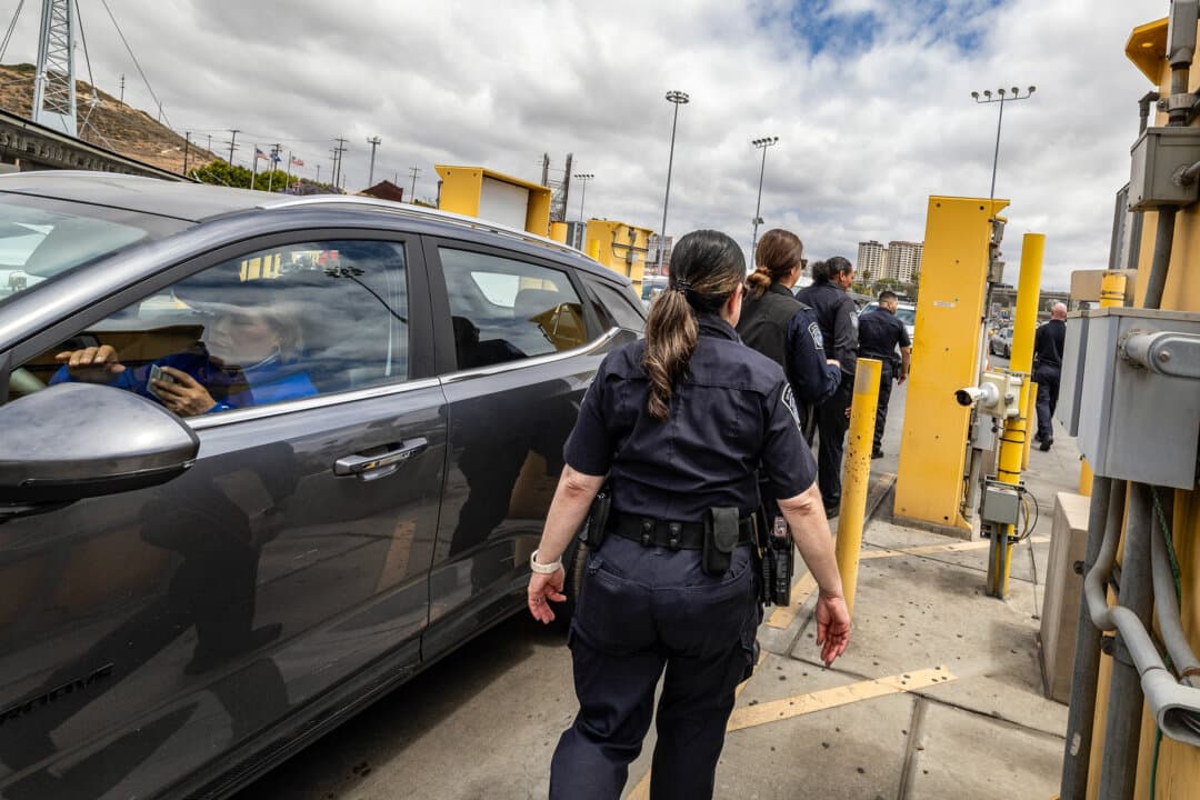 U.S. Customs and Border Protection agents walk through the vehicular entry of the San Ysidro Port of Entry near San Diego on May 26, 2026. (John Fredricks/The Epoch Times)
