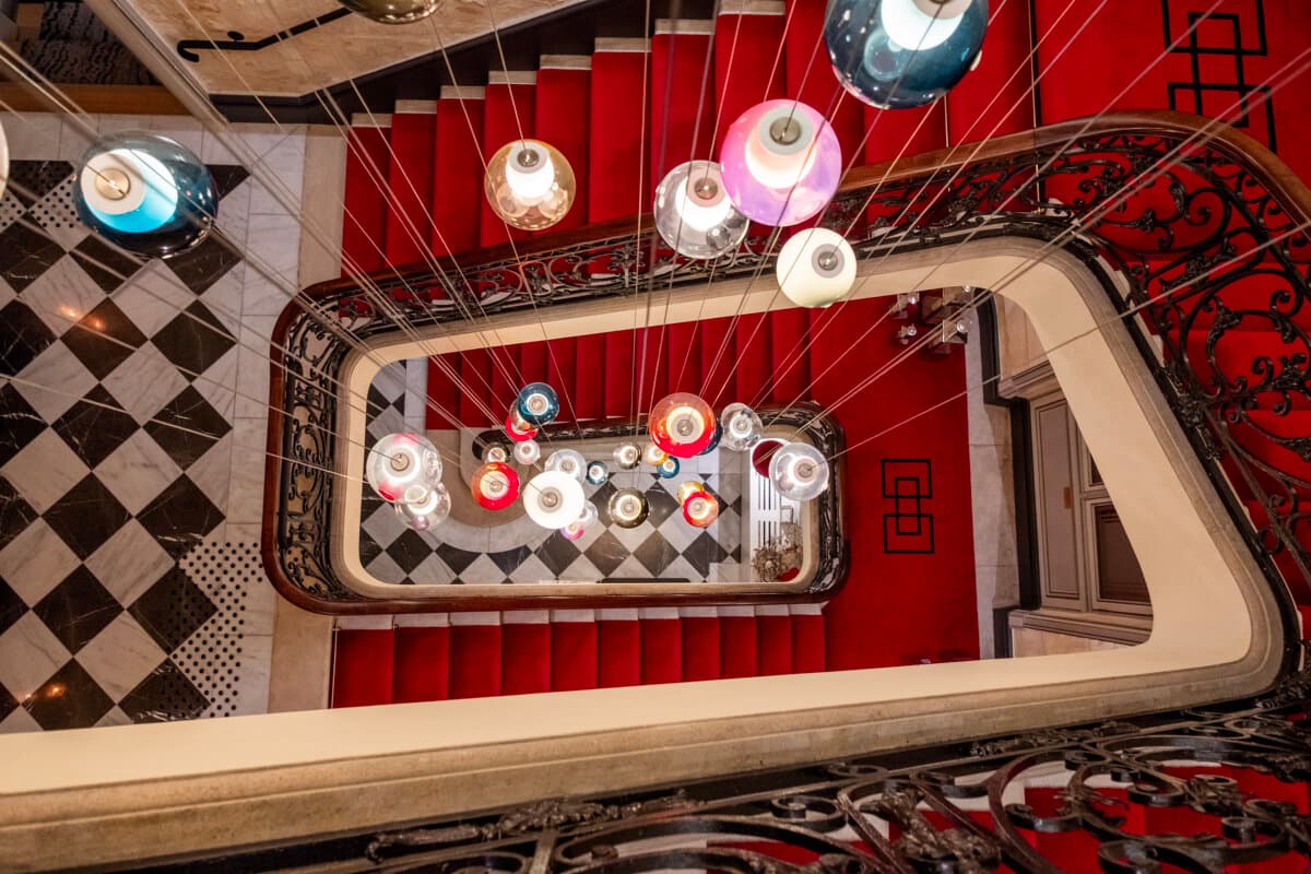 Checkerboard floors to red velvet, rising into quiet elegance at Villas Foch. (Benjamin Myers/TNS