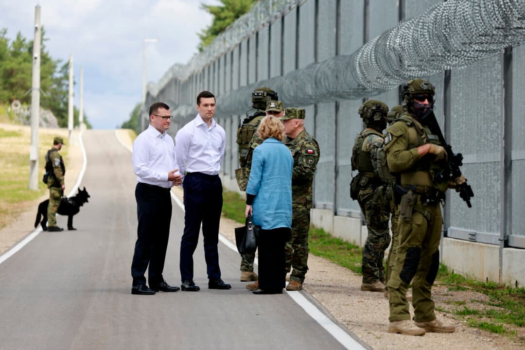 French far-right Rassemblement National (RN) party's President, member of the European Parliament, and president of the Patriots for Europe (PfE) group Jordan Bardella (2nd L) and Poland's Chief of Cabinet Pawel Szefernaker (L) listen to Deputy Commander of the Podlaski Border Guard Unit Andrzej Stasiulewicz (5th L) during a visit to Poland's border with Belarus near Kuznica, Poland, on June 19, 2026. Bardella is on a two-day visit to Poland for meetings with leaders of Poland's far right and touring the eastern border, marking the latest stop on his overseas tour aimed at strengthening his European alliances a few months before the French presidential election. (Wojtek Radwanski/AFP via Getty Images)