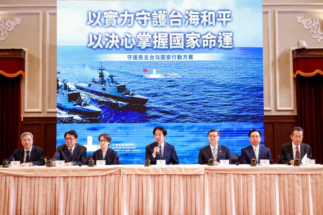 (L-R) Taiwan's Minister of Economic Affairs Kung Ming-hsin, Secretary-General to the President Pan Men-an, Vice President Hsiao Bi-khim, President Lai Ching-te, Taiwan's Premier Cho Jung-tai, Secretary-General of the National Security Council Joseph Wu, and Defense Minister Wellington Koo hold a news conference at the presidential office building in Taipei on Nov. 26, 2025. Despite a population of just over 23 million, Taiwan punches far above its weight in the global marketplace. (I-Hwa Cheng / AFP via Getty Images)