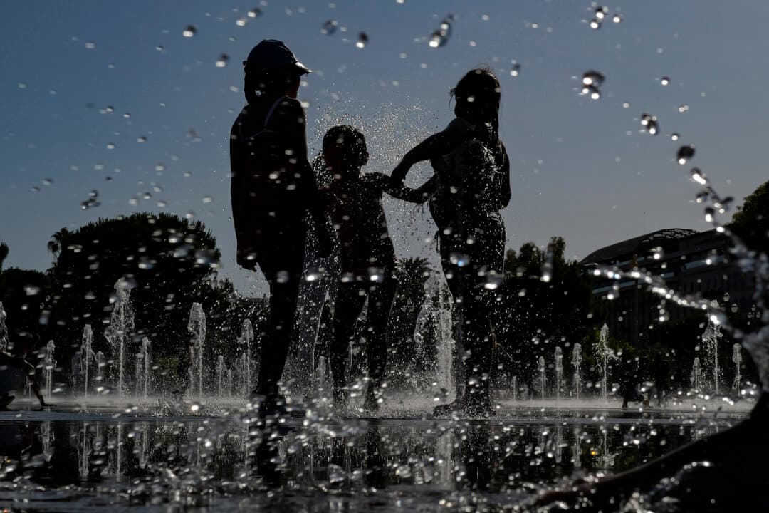 Children play in a water mirror fountain in the French riviera city of Nice on June 19, 2026. A heatwave that hit France is set to continue for several more days with temperatures expected to reach up to 104°F in some areas on June 21, the first day of summer. (Valery Hache/AFP via Getty Images)