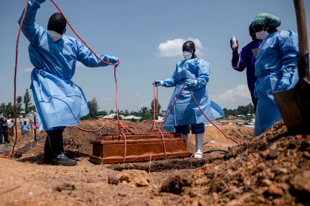 Teams from the International Federation of the Red Cross and Red Crescent societies at Mbiyo cemetery prepare for burial the body of a fourth orphan who died from Ebola virus disease at an orphanage in Bunia, Ituri Province, Congo, on June 19, 2026. (Jospin Mwisha/AFP via Getty Images)