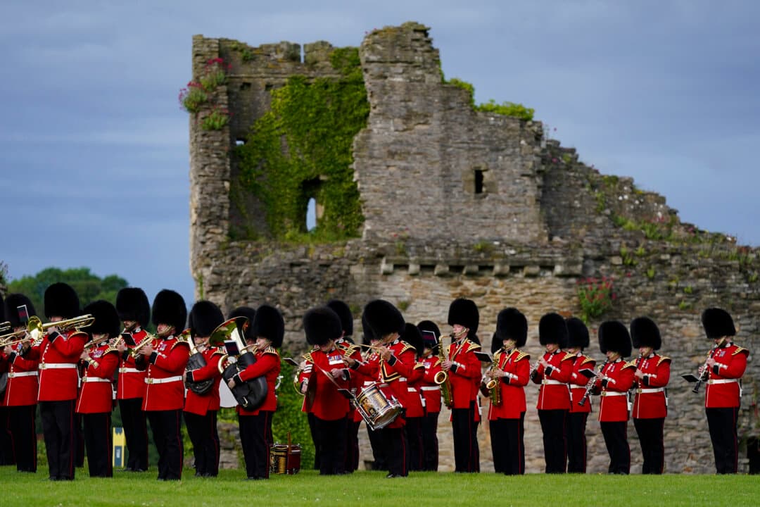 Bandsmen from the 1st Battalion Scots Guards perform the Beating Retreat at Richmond castle in Richmond, England, on June 19, 2026. Beating Retreat is a historic military ceremony that originated in the 17th century. Originally a practical field signal where drums were beaten at sunset to order troops to cease fighting, return to camp, and close gates, it has evolved into a grand ceremonial display of military music, precision marching, and lowering of the flag. (Ian Forsyth/Getty Images)