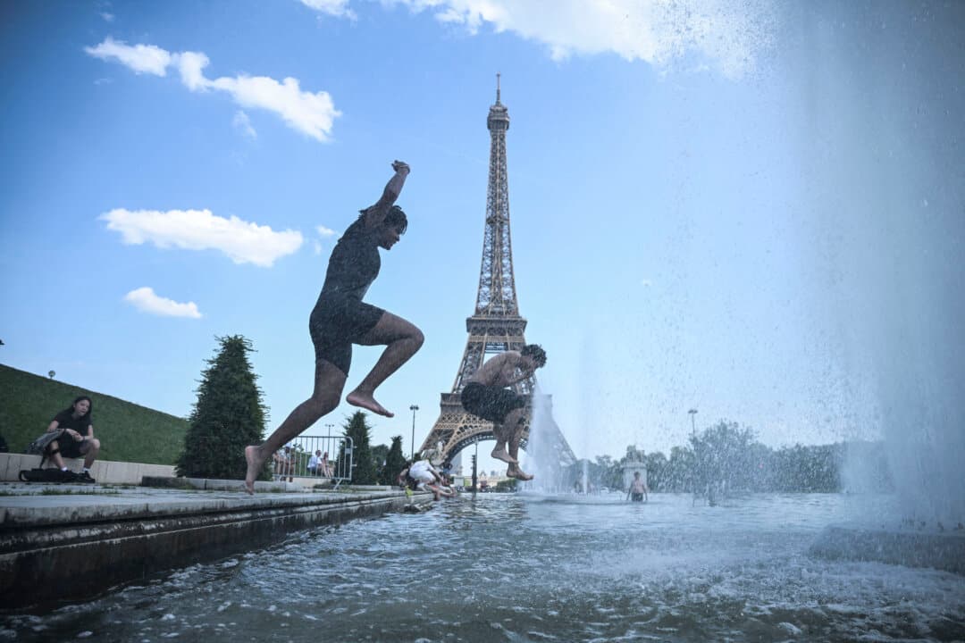People jump in the Trocadero Fountain near the Eiffel Tower during a heatwave in Paris on June 22, 2026. The latest bout of exceptionally high temperatures to hit Europe has seen outdoor events canceled, transport disrupted, schools shut, and office workers told to work from home, as the authorities issued health alerts to protect the elderly and vulnerable. (Julien de Rosa/AFP via Getty Images)