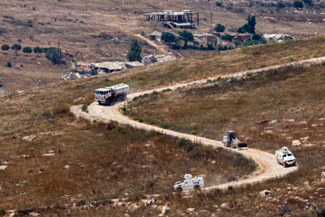 A United Nations Interim Force in Lebanon convoy drives past destroyed buildings in southern Lebanon on June 22, 2026. (Jalaa Marey/AFP via Getty Images)