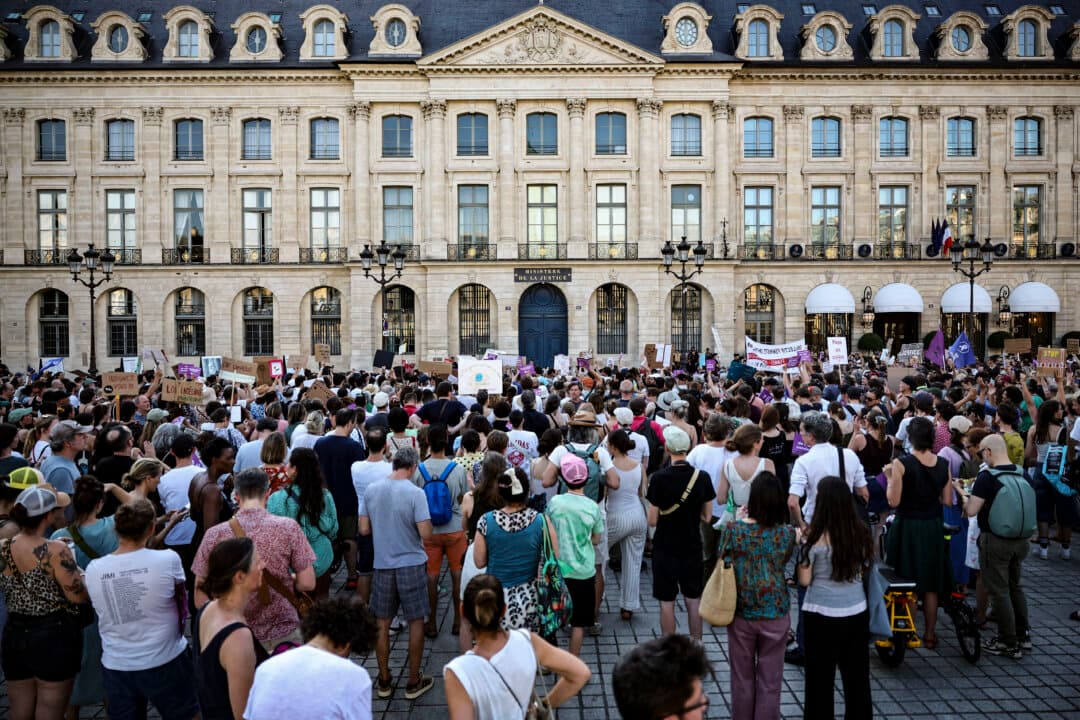 Protesters hold placards during a demonstration at Place Vendome outside the French Justice Ministry in Paris, on June 22, 2026, to demand a law against violence on minors, following the death of Lyhanna, an 11-year-old girl found dead on June 4 after being reported missing on May 29. (Simon Wohlfahrt/AFP via Getty Images)