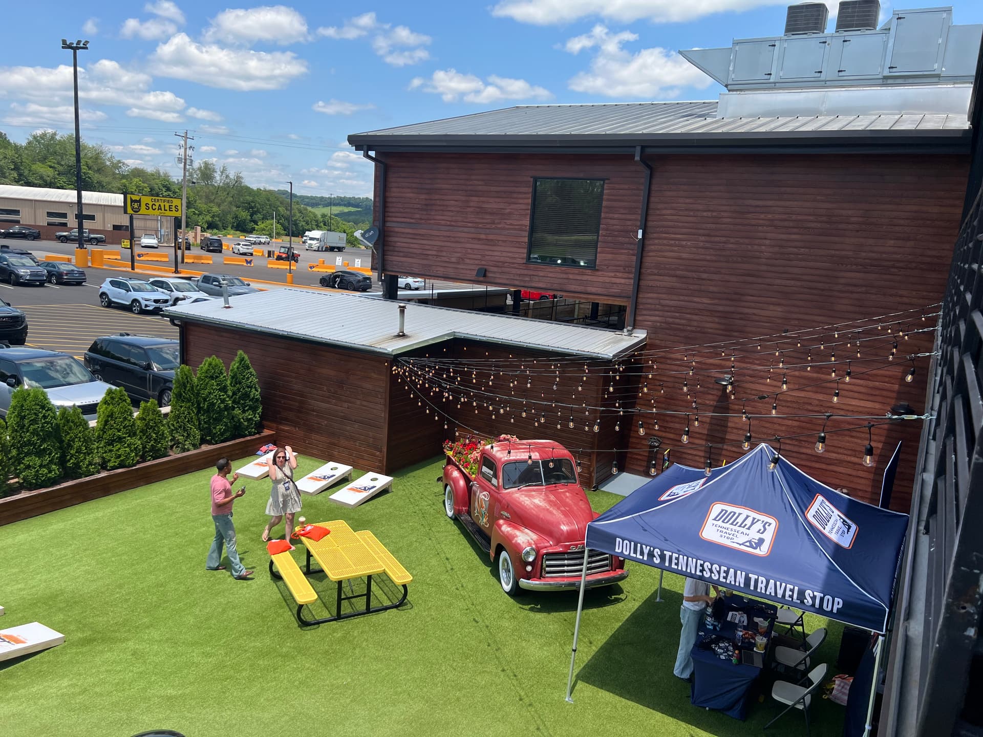 Dolly Parton’s truck stop has a turf patio with outdoor seating and cornhole boards. (Jacki Thrapp/The Epoch Times)