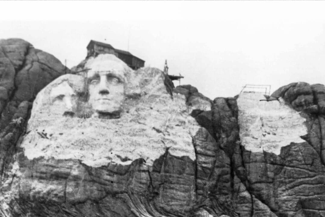 The unfinished surface of Mount Rushmore looms with Thomas Jefferson at left, before unstable rock necessitated a design change, near Keystone, S.D., in this file photo. (Courtesy of South Dakota Historical Society)