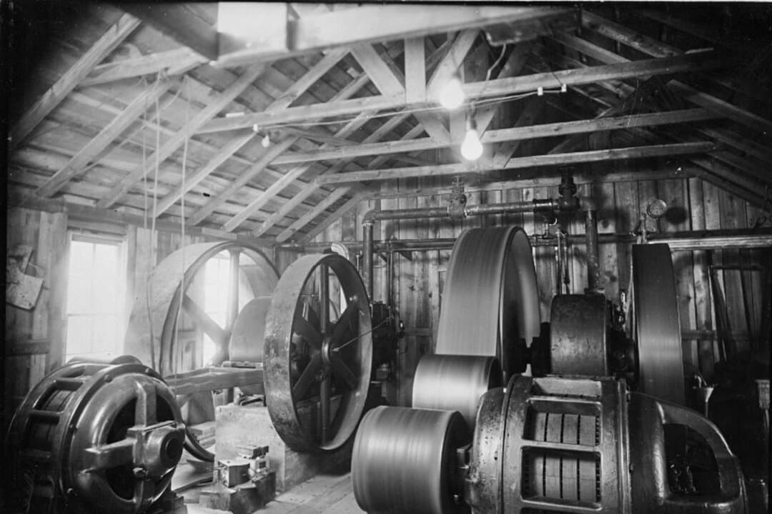 (Left) Compressors are stored during the construction of Mount Rushmore near Keystone, S.D., in this file photo. (Right) Sculptor Gutzon Borglum works on Mount Rushmore models near Keystone, S.D., in this file photo. Borglum crafted scale models of the presidents’ heads, then devised a way to transfer their proportions to the mountain. (Courtesy of South Dakota Historical Society)