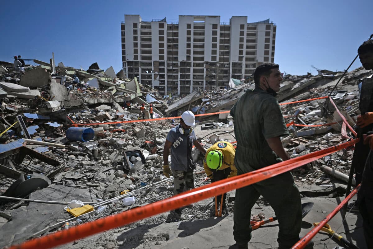 Rescue workers and volunteers look for missing people amid the rubble at Los Cocos beach, in Caraballeda, La Guaira state, Venezuela, on July 1, 2026. (Juan Barreto / AFP via Getty Images)