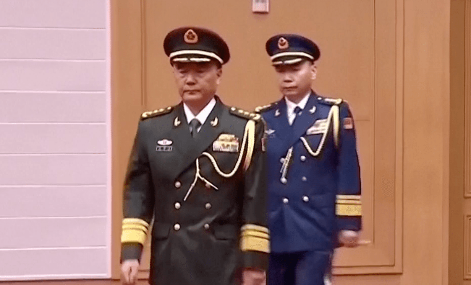 Zhang Shuguang, secretary of the discipline inspection commission, and Wang Gang, commander of the People's Liberation Army Air Force, walk in a general promotion ceremony in Beijing on July 3, 2026. (CCTV via Reuters/Screenshot via The Epoch Times)